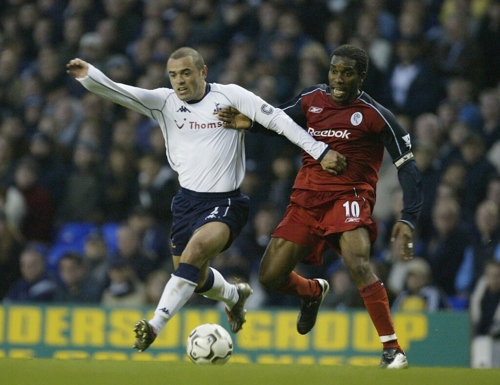 Jay Jay Okoccha of Bolton tries to tackle Stephen Carr of Tottenham Hotspur