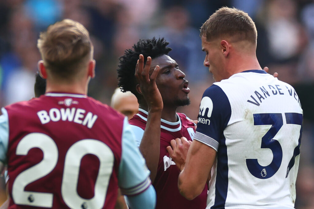 Mohammed Kudus of West Ham United clashes with Tottenham's Micky van de Ven