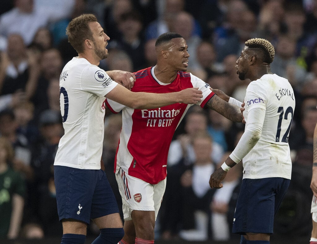 Harry Kane of Tottenham holds back Gabriel of Arsenal