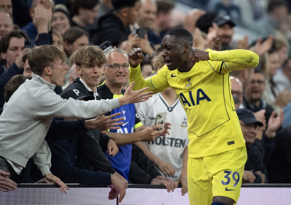 Randal Kolo Muani celebrates in yellow Tottenham kit