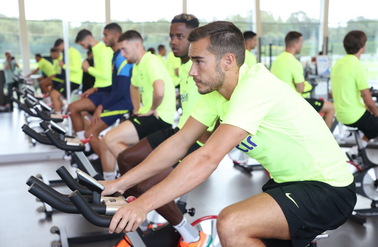 Harry Winks rides an exercise bike during training